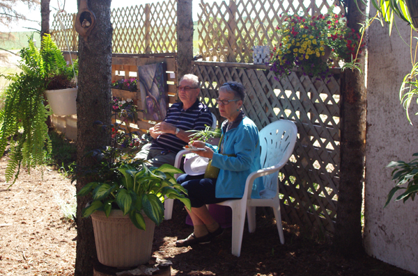 Guests enjoying snacks in the shade garden.